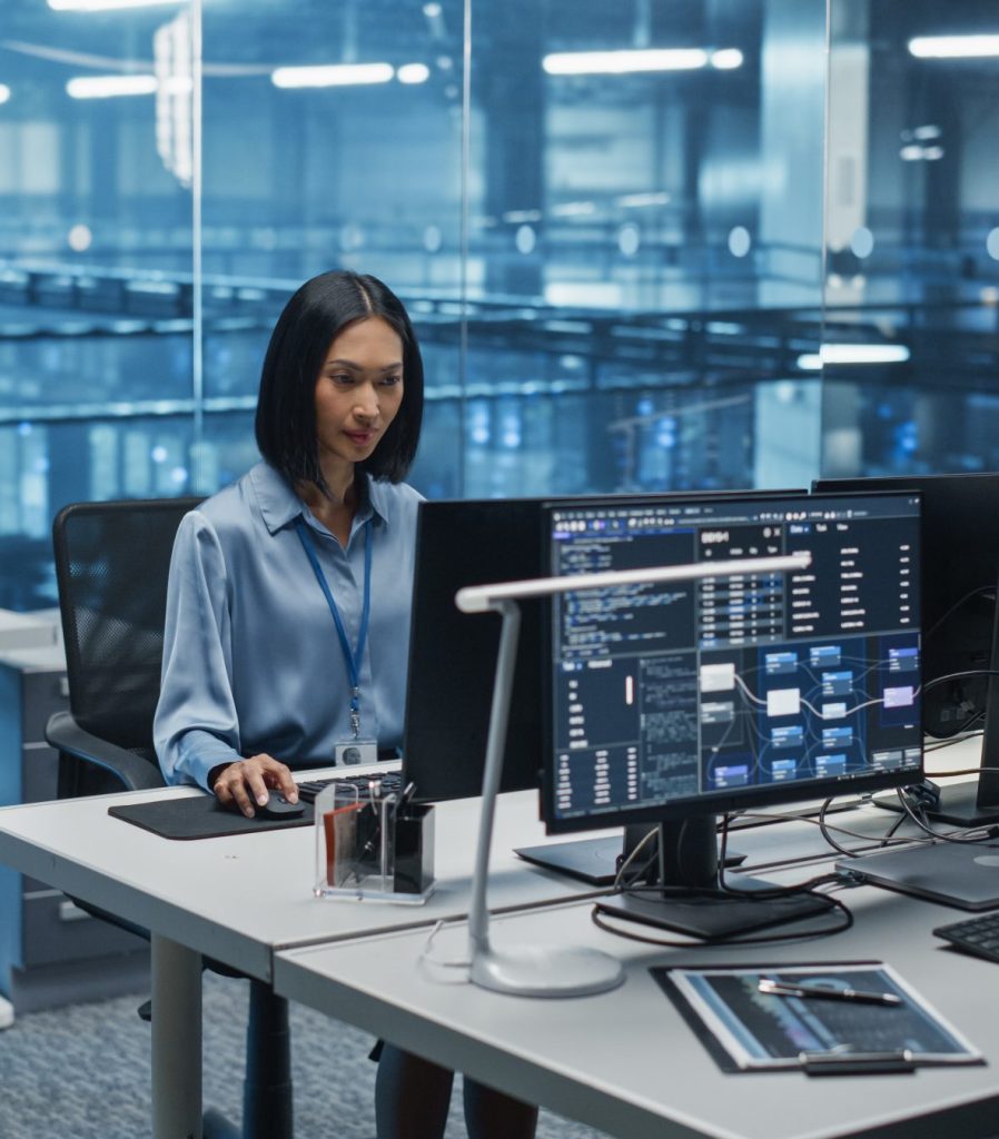 woman coding at her computer inside a data centre IT office
