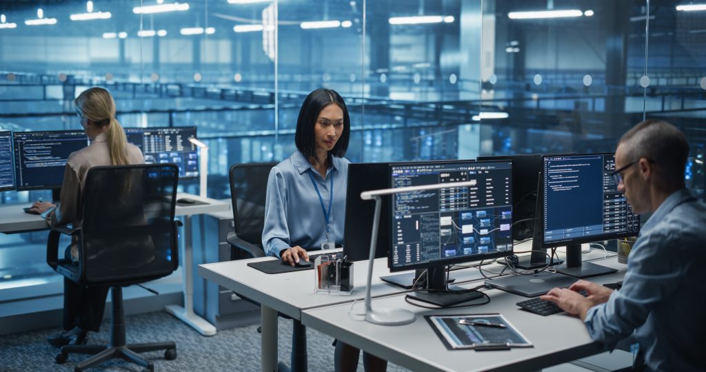 Female Software Developer working in IT Office of a high-tech data centre